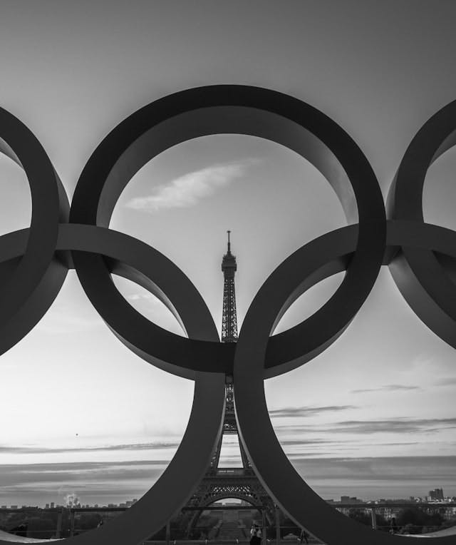 the olympic rings in front of the eiffel tower